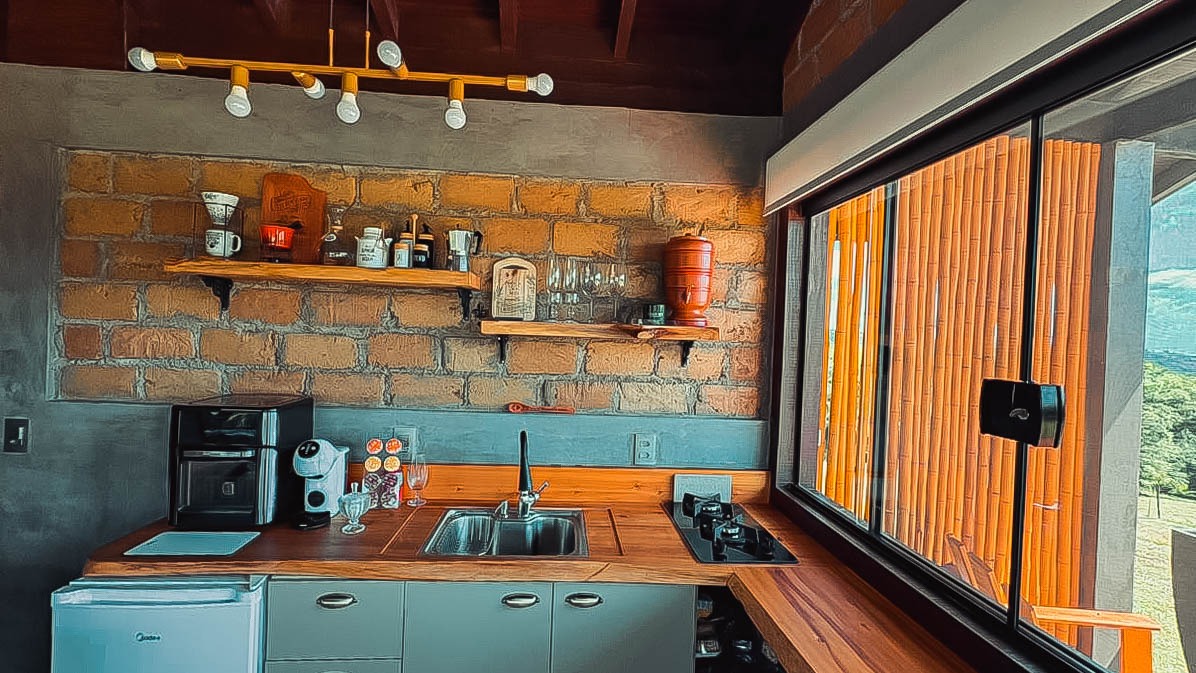 Interior aconchegante de um chalé com cama arrumada e ambiente rústico